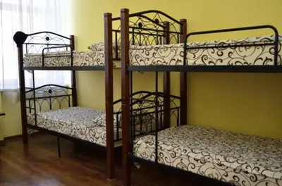 two bunk beds in a room with a window at PETRA Cabin Dorms Hostel in Wadi Musa