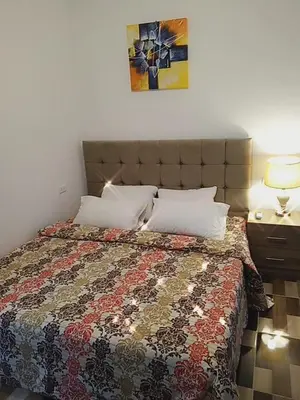 a bed with a quilt and pillows in a bedroom at Petra Planet in Wadi Musa