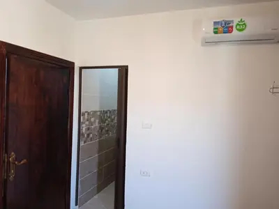 a bathroom with a door and a mirror at Petra Planet in Wadi Musa