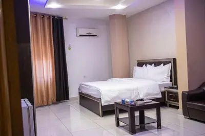 a hotel room with a bed and a table at Sara Crown Hotel in Irbid