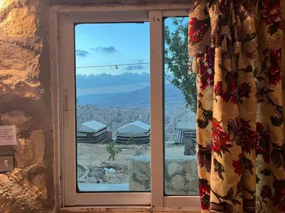 a window with a view of the desert at Al-Nawatef ECO camp- Dana Nature Reserve in Dana