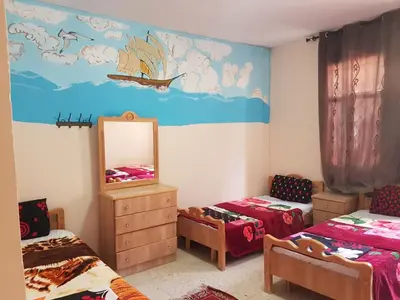 a bedroom with two twin beds and a mirror at Dana moon Hotel in Dana