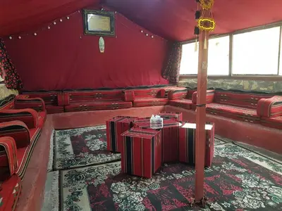 a red room with red chairs and a table at Dana moon Hotel in Dana