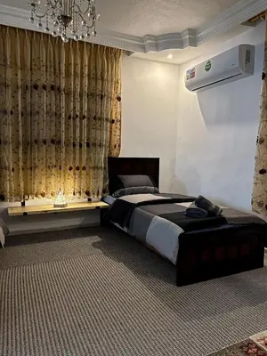 a bedroom with a large bed and a chandelier at Euphoria guest house in Wadi Musa