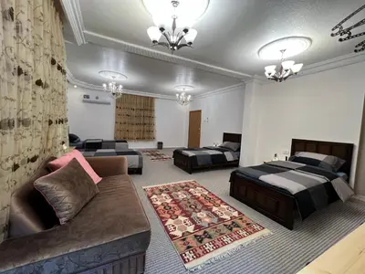 a living room with two beds and a couch at Euphoria guest house in Wadi Musa