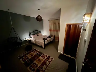 a bedroom with a bed and a rug at Euphoria guest house in Wadi Musa