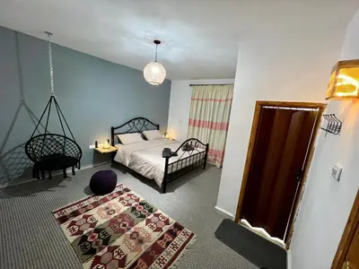 a bedroom with a bed and a chandelier at Euphoria guest house in Wadi Musa