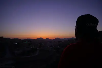 a person watching the sunset from the top of a hill at Petra Sofsaf Hotel in Wadi Musa