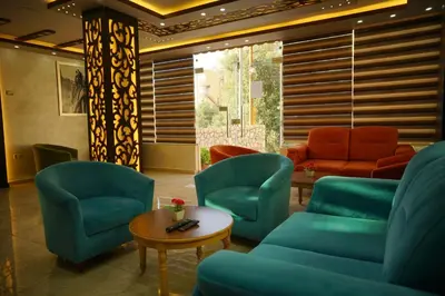 a waiting room with blue chairs and a couch at Petra Sofsaf Hotel in Wadi Musa