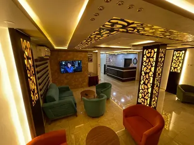 a lobby with chairs and a tv in a building at Petra Sofsaf Hotel in Wadi Musa