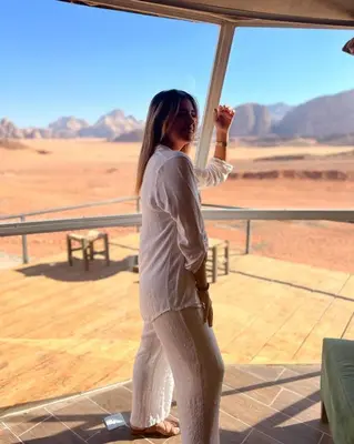a woman standing in front of a view of the desert at Wadi Rum Nova camp in Wadi Rum