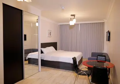 a hotel room with a bed and a table at Abu Alsoud Hotel in Amman