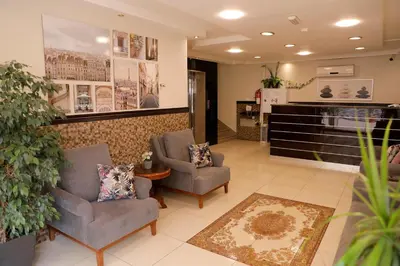 a waiting room with two chairs and a table at Abu Alsoud Hotel in Amman