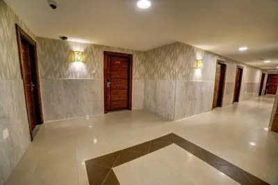 a large hallway with doors and a tile floor at Nairoukh Hotel Aqaba in Aqaba