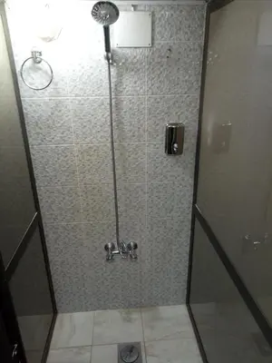 a shower with a glass door in a bathroom at Happy Night Hostel in Wadi Musa