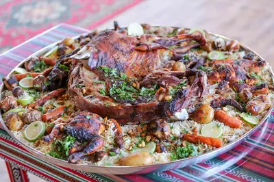 a plate of food with meat and vegetables on a table at Arena Desert Camp & Adventurers in Wadi Rum