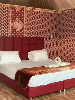 a bed with two swans sitting on top of it at sand magic camp in Wadi Rum