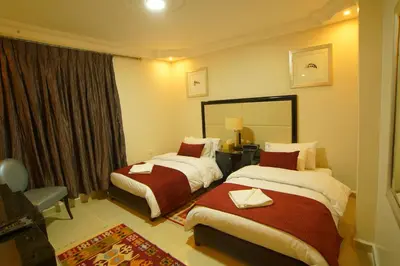a hotel room with two beds and a mirror at Over Mountains Hotel in Wadi Musa