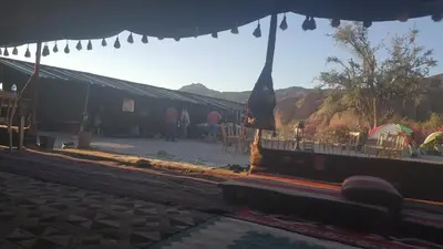 a large tent with people standing outside of it at Wadi Ghwere Camp مخيم وادي الغوير in Al Khuraybah