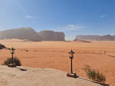 two lights in the desert with mountains in the background at Wadi Rum Caravan Camp in Wadi Rum