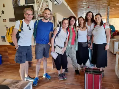 a group of people standing in a room with luggage at Petra Cabin Hostel in Wadi Musa