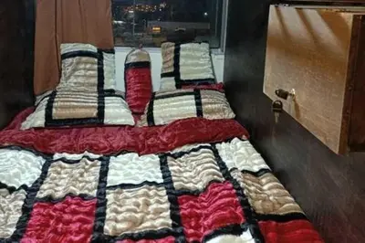 a group of three beds in a room at Petra Cabin Hostel in Wadi Musa