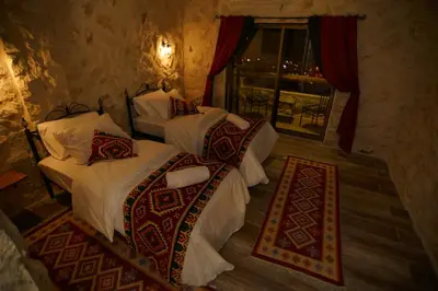 a bedroom with two beds and a window at Infinity Lodge in Wadi Musa
