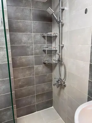 a bathroom with a shower with a toilet and a sink at شركة مسايا لشقق المفروشة in Irbid