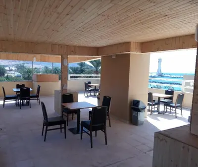 a restaurant with tables and chairs and a view of the eiffel tower at La Riva Hotel in Aqaba