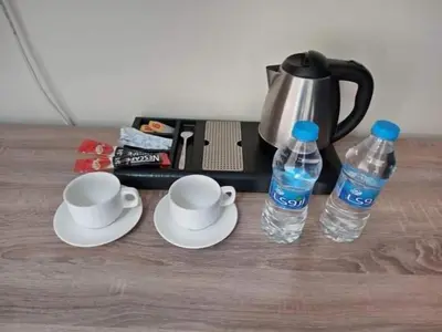 two cups and two bottles of water on a table at La Riva Hotel in Aqaba