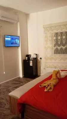 a bedroom with a bed with a flat screen tv on the wall at Bubble castle in Kerak