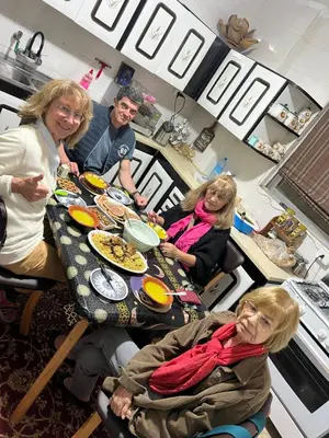 a group of people sitting at a table in a kitchen at the old house in Kerak