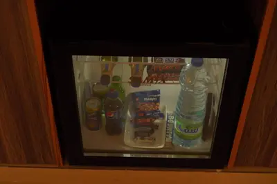 a refrigerator filled with drinks and bottles of water at Petra Plaza Hotel in Wadi Musa