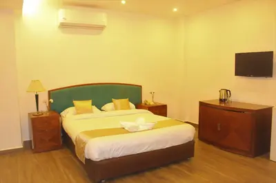 a bedroom with a large bed and a television at New MerryLand Hotel in Amman