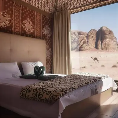 a bedroom with a bed with a view of a desert at One Thousand and One Nights Camp in Wadi Rum