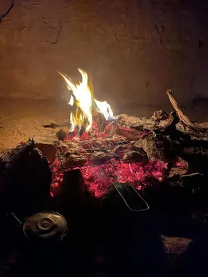 a fire is burning in an oven with flames at Rum Panoramic Camp & Tour in Wadi Rum