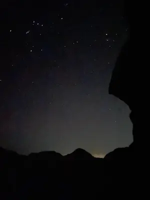 a starry night with a person looking at the sky at Rum Panoramic Camp & Tour in Wadi Rum