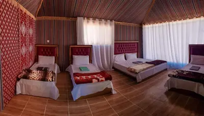 a room with three beds in a room at WADI RUM STAR WARS CAMP in Wadi Rum