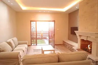 a living room with a couch and a fireplace at Dar Gerasa chalets - شاليهات دار جراسا in Jerash