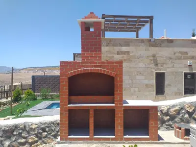 a brick pizza oven in the middle of a building at Dar Gerasa chalets - شاليهات دار جراسا in Jerash