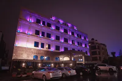 a building with purple lights on top of it at Strand Hotel Jordan in Amman