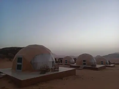 a group of domes in the middle of the desert at Wadi Rum Maracanã camp in Wadi Rum