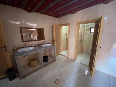 a bathroom with two sinks and a shower at Wadirum momoo in Wadi Rum