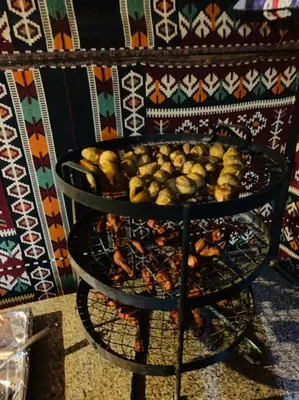 two plates of food on a stand next to a wall at Wadirum momoo in Wadi Rum