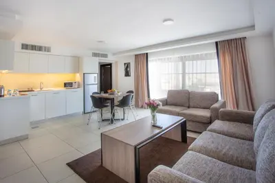a living room with a couch and a table at Triple A Hotel Suites in Amman
