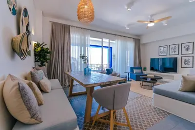 a living room with a couch and a table at Cloud 7 Residence Ayla Aqaba in Aqaba