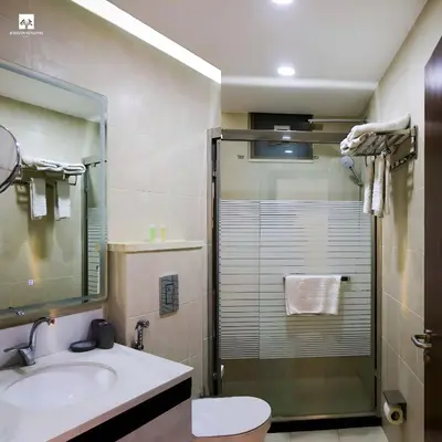 a bathroom with a shower and a sink and a toilet at Jordan Seasons Hotel in Aqaba