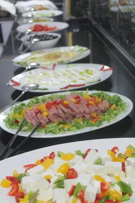 a row of plates of food on a table at Jordan Seasons Hotel in Aqaba