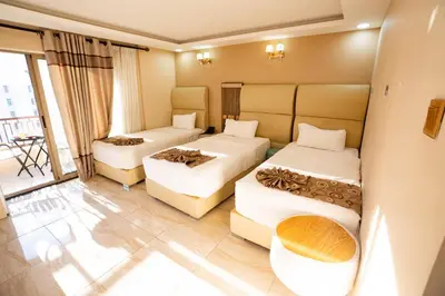 a hotel room with two beds and a couch at Jordan Seasons Hotel in Aqaba