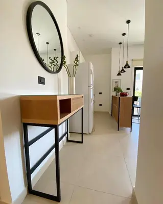 a room with a table and a mirror on the wall at Nu Fifty Two in Amman